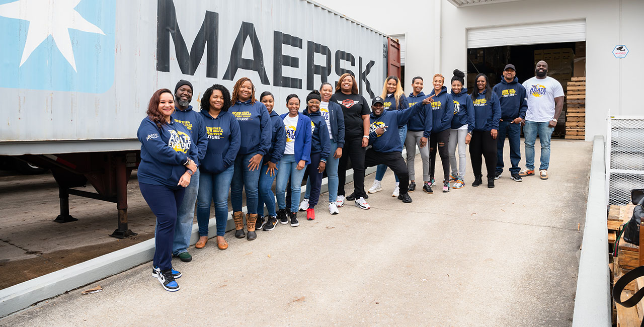 Agate Scholars in front of warehouse and shipping container